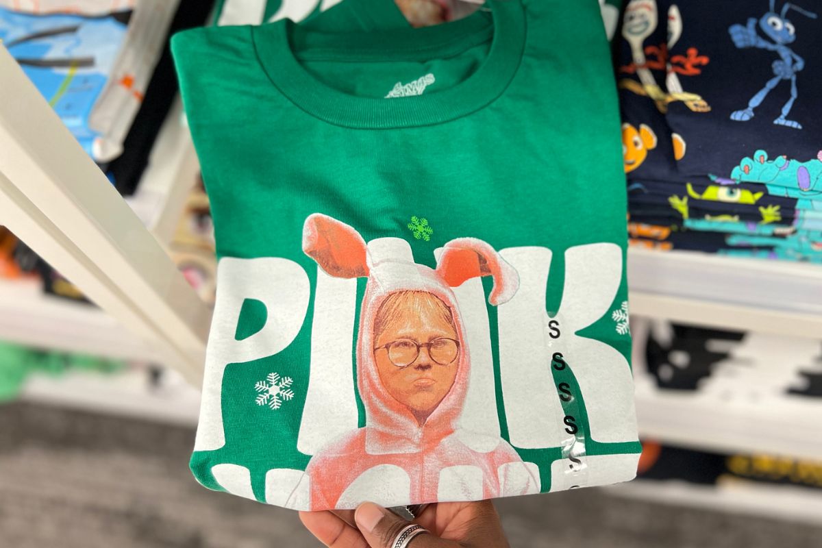 Green t-shirt that has a graphic of Ralphie from A Christmas story in his bunny costume with Pink Nightmare printed around him