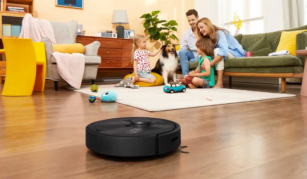 black robot vacuum on wood floor