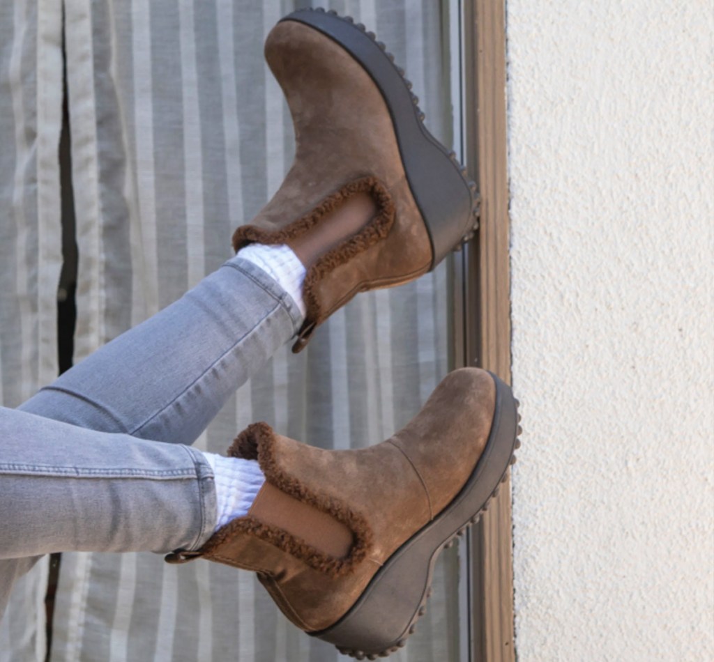 person wearing brown boots