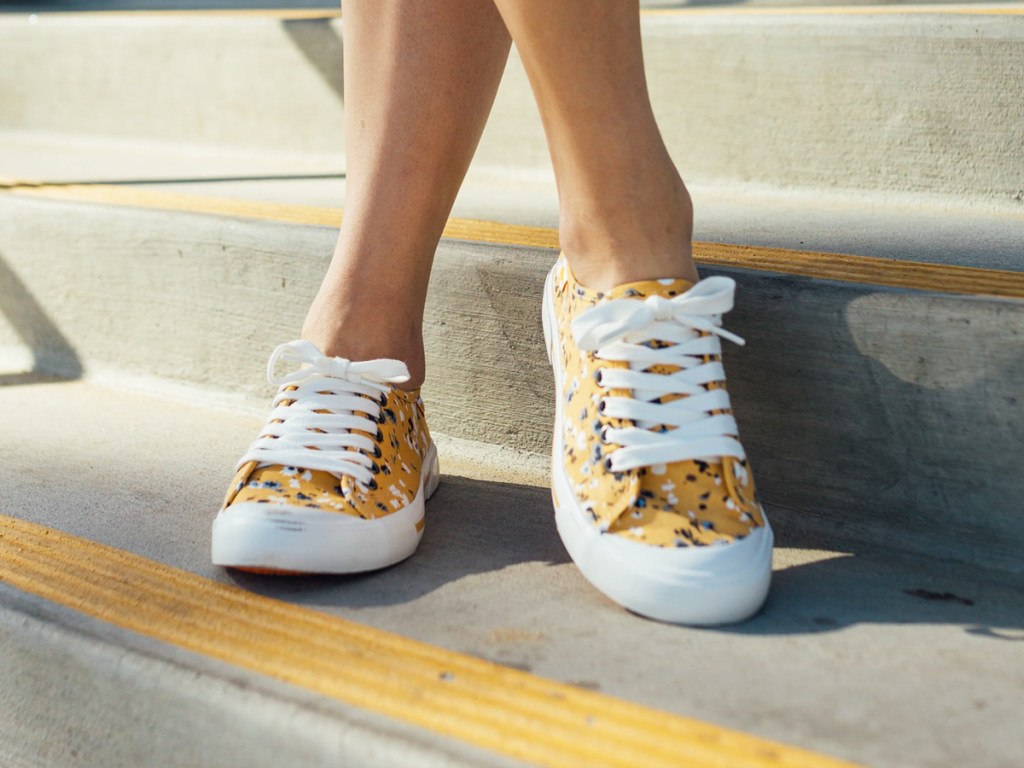woman wearing yellow floral print sneakers