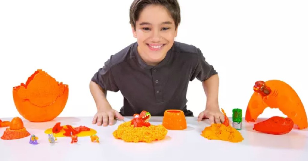boy with orange toys on table