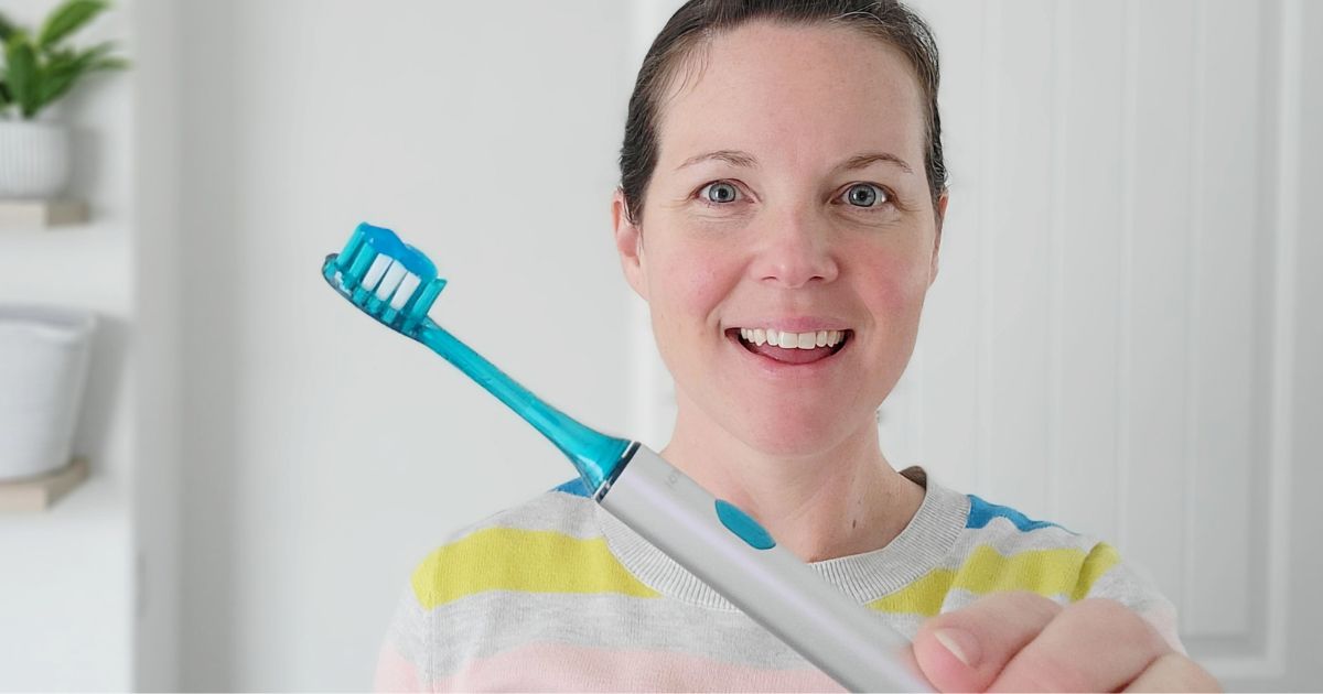 woman holding a Soocas Toothbrush