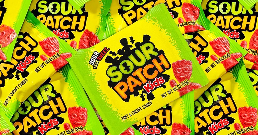 pile of small green packets of Sour Patch Kids