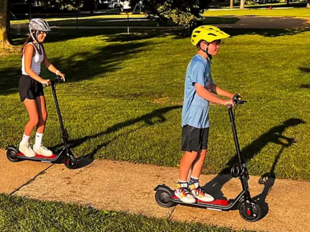 Two kids riding Seway Scooters