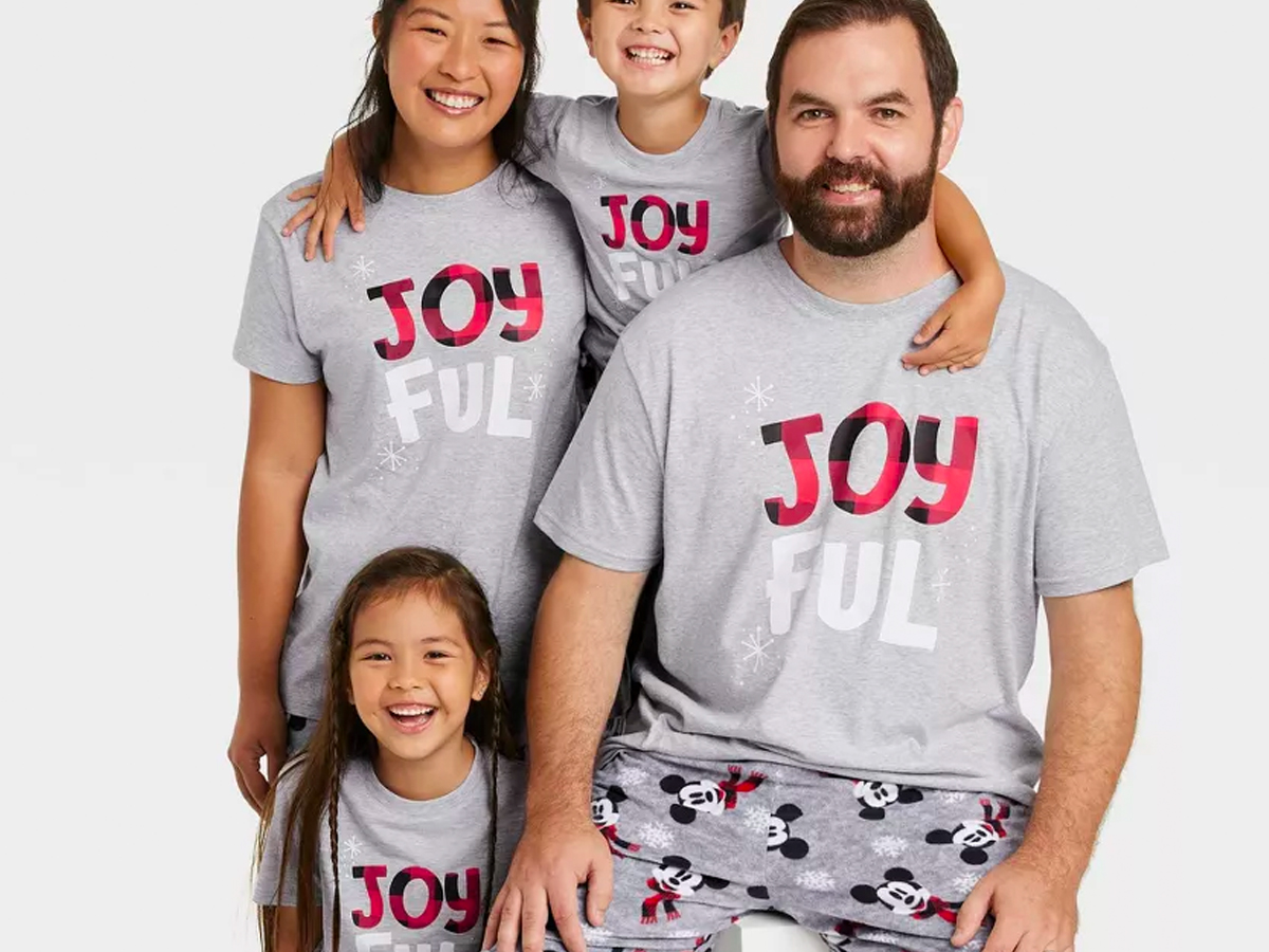 family wearing matching target christmas pajamas with mickey on the pants