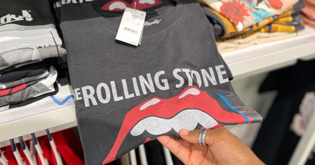 woman's hand holding a folded Rolling Stones Graphic T-Shirt