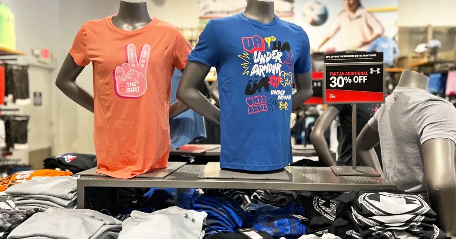 under armour tops display in store with 30% off sale tag
