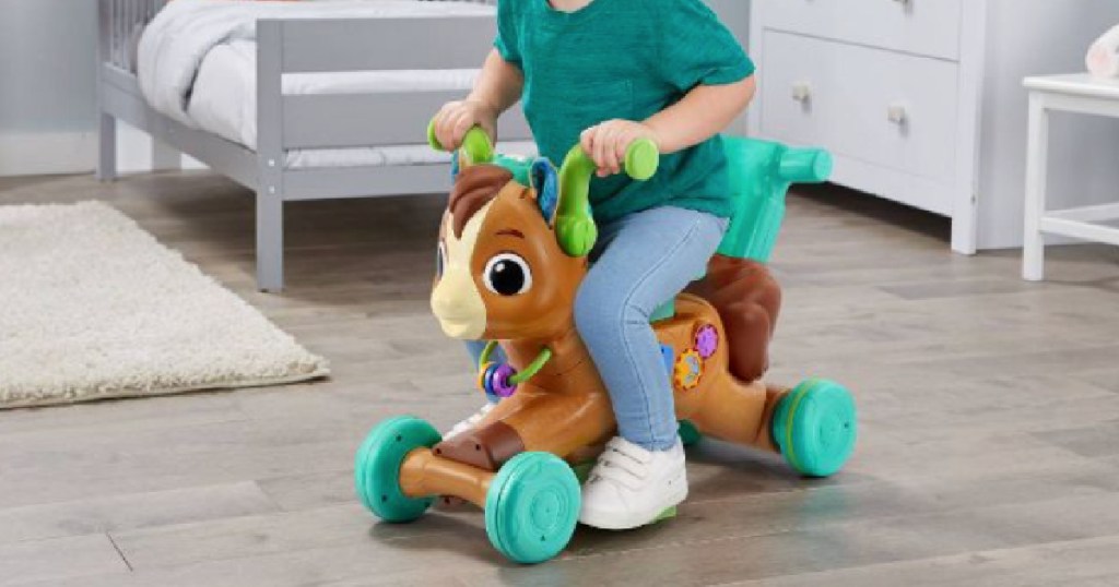child riding on toy pony