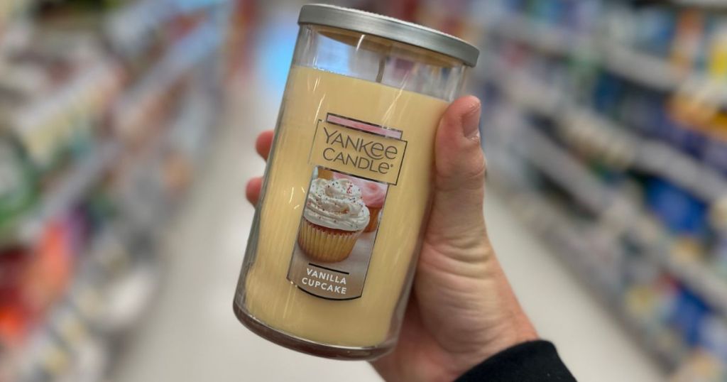 Hand holding a Yankee Candle pillar candle