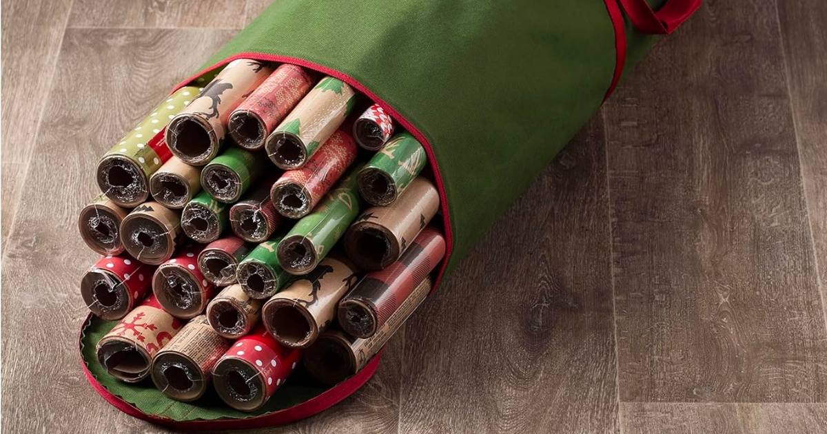 green wrapping paper storage bag on floor with wrapping paper rolls inside