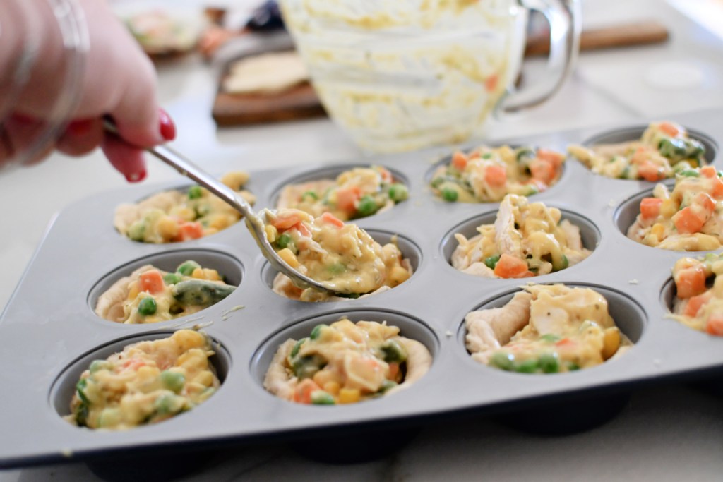 adding filling to muffin pan