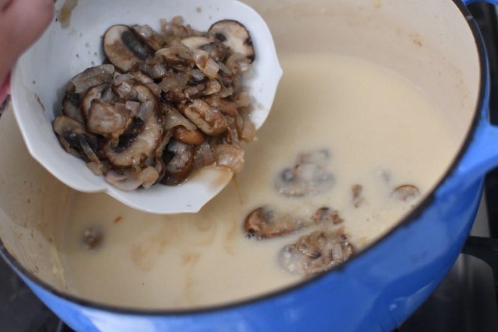 adding sautéed mushrooms to soup