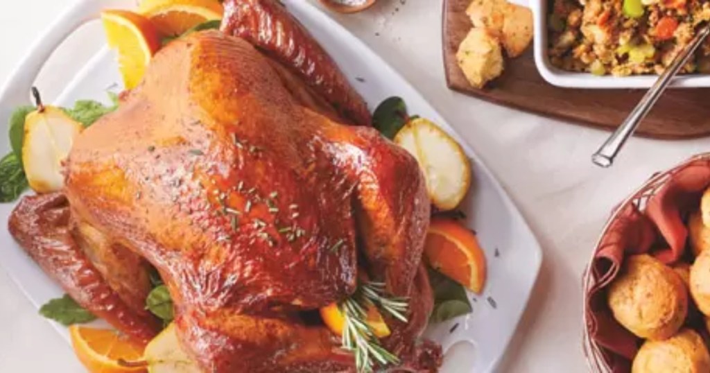 prepared turkey on table with rolls and stuffing