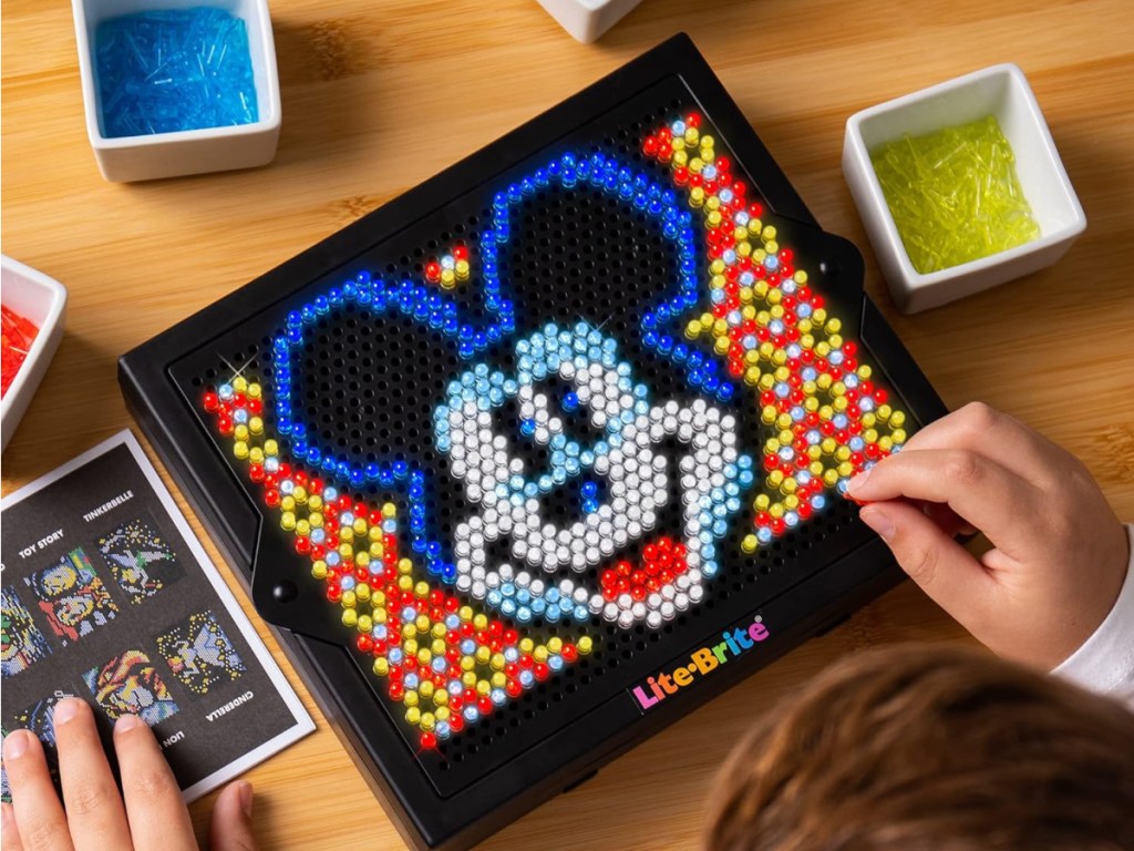 child playing Lite-Brite Super Bright HD Disney 100 Years of Wonder Toy