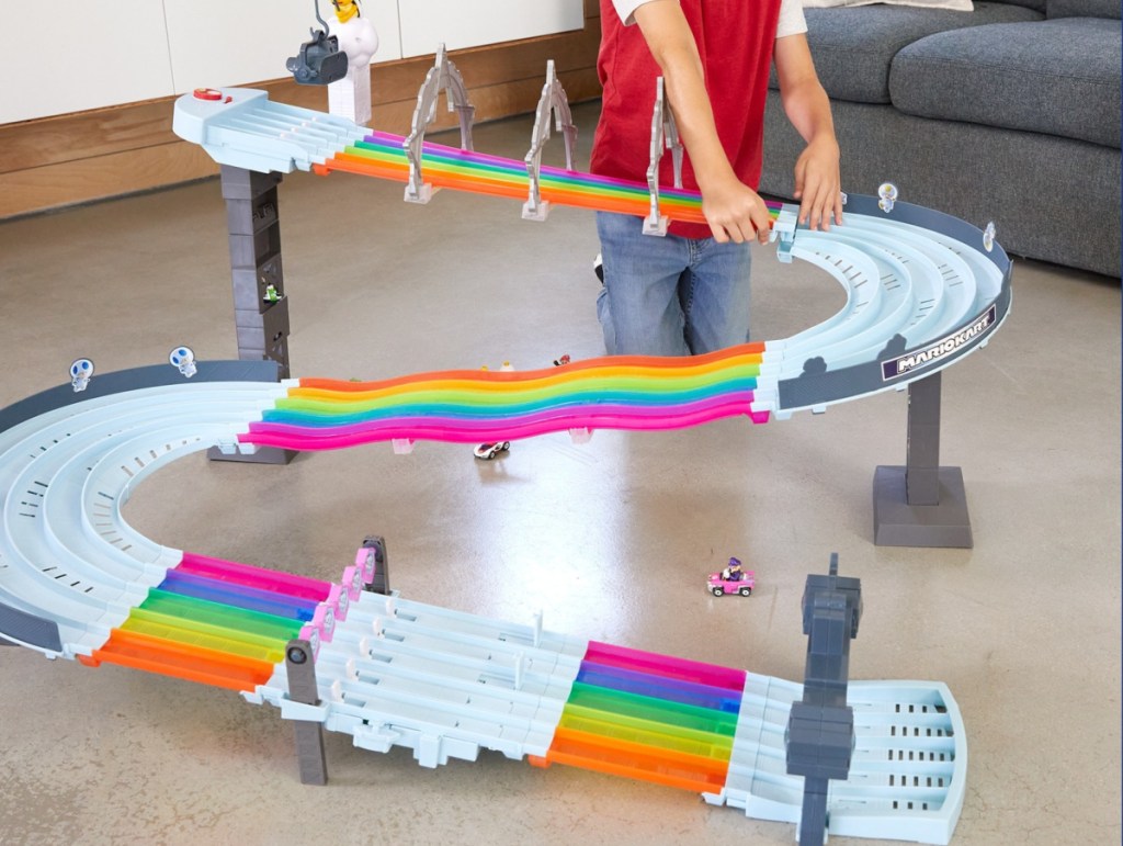 child playing with Hot Wheels Mario Kart Rainbow Road Raceway Track Set