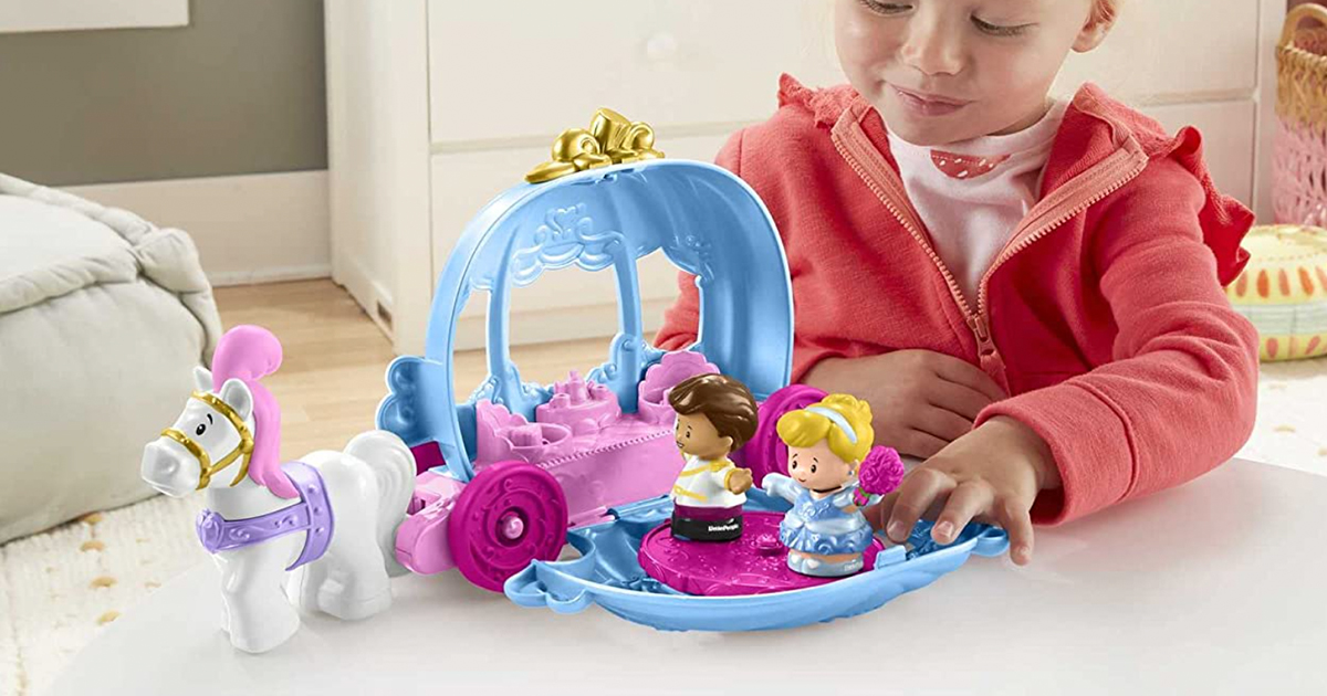 young girl playing with a disney princess cinderella carriage playset