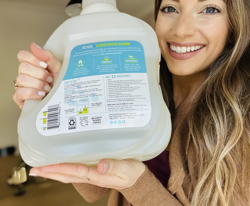 woman holding bottle of liquid detergent