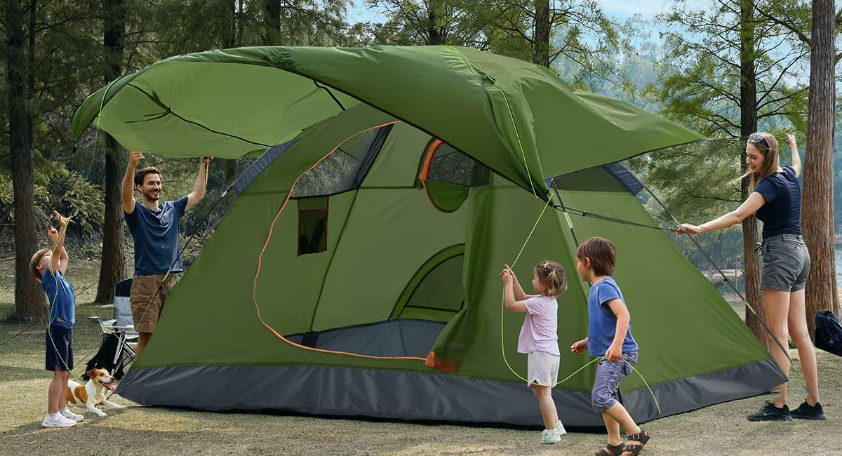 ciays camping tent being put up by two adults and three kids