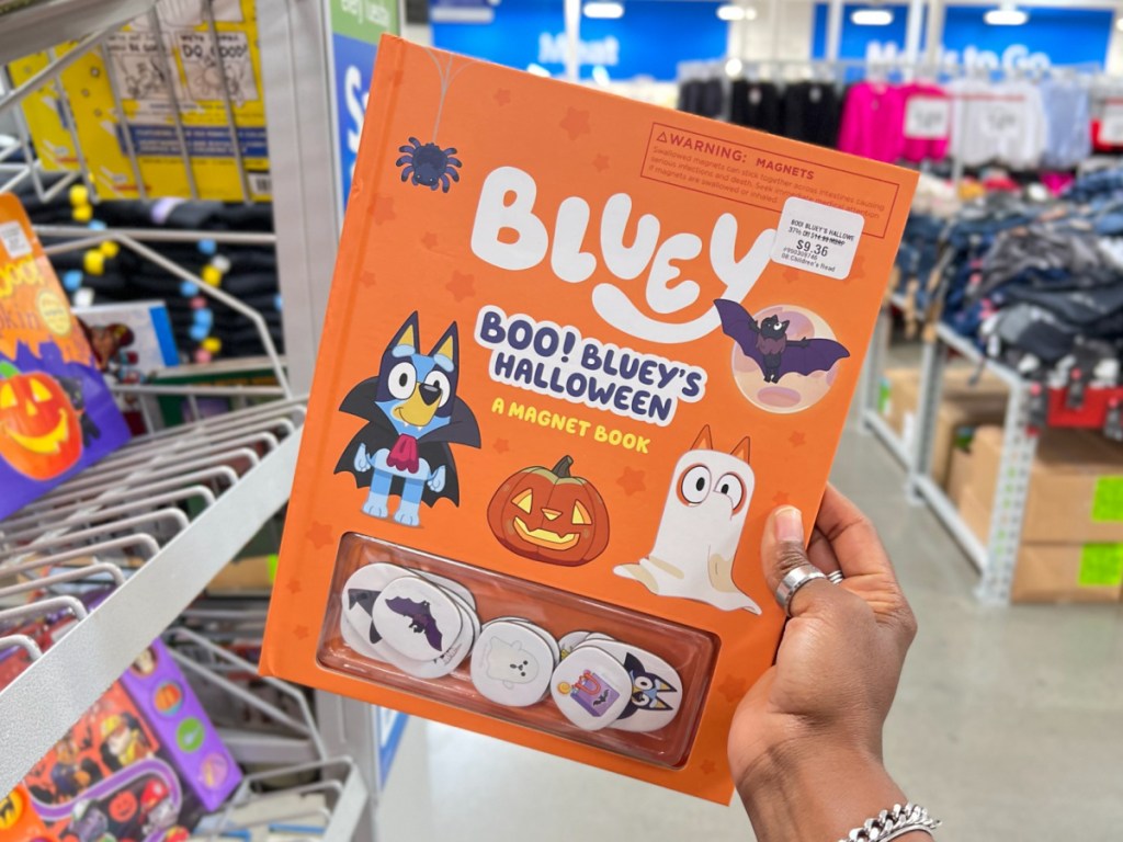 hand holding Boo! Bluey's Halloween_ A Magnet Book at the sams store