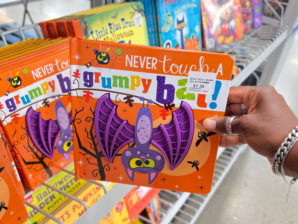 hand holding Never Touch a Grumpy Bat at the sams store