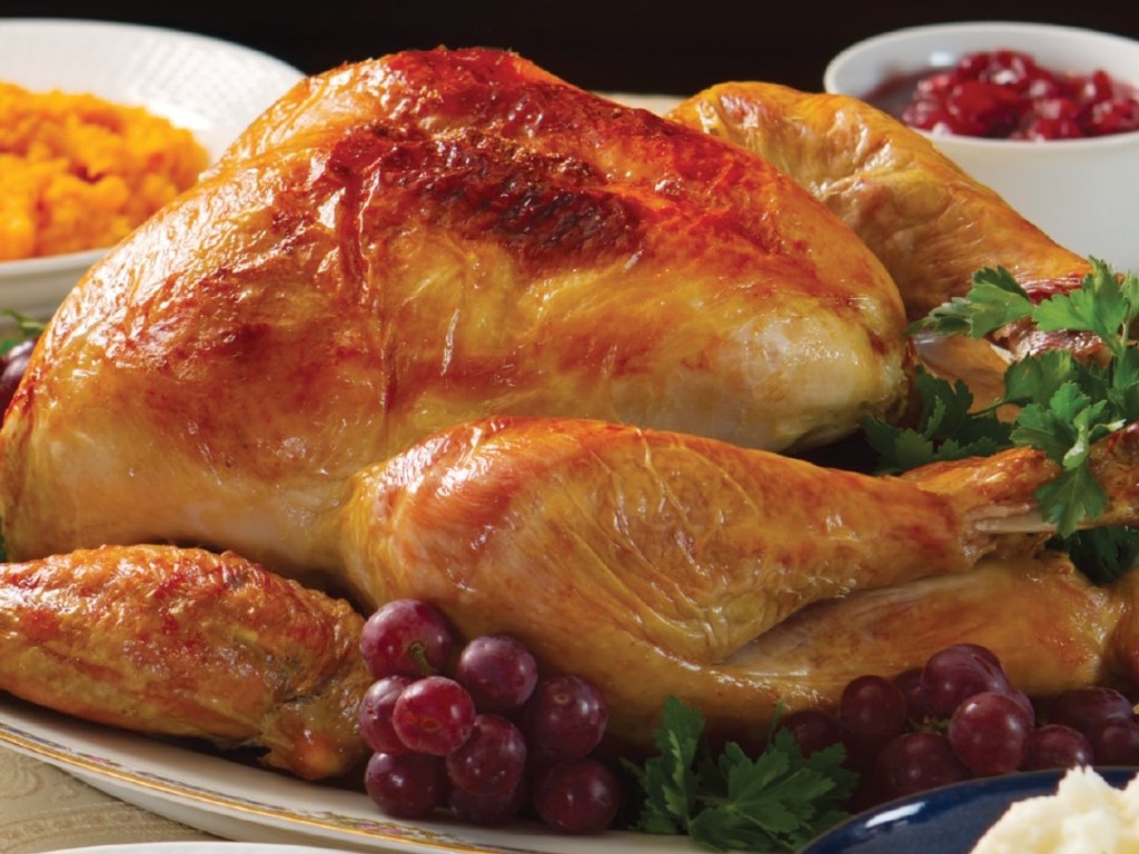 roasted turkey on table with side dishes