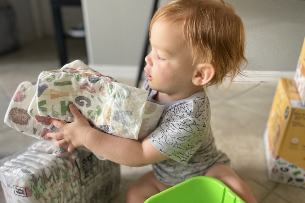 toddler boy playing with hello bello diapers