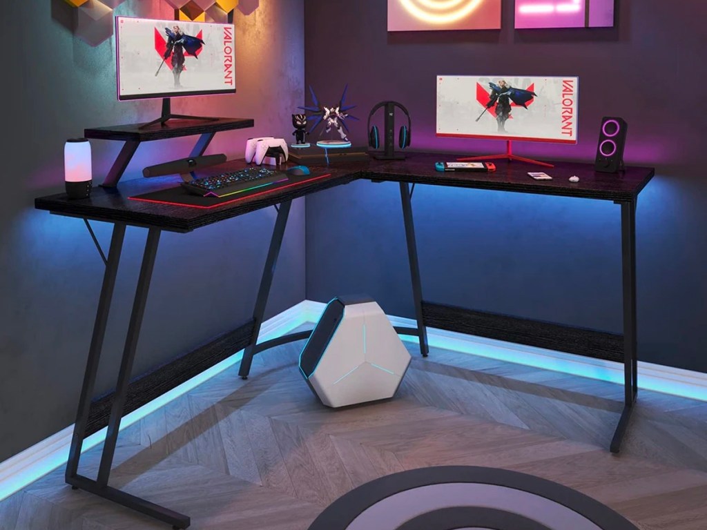 black l shaped gaming desk with computer monitors 