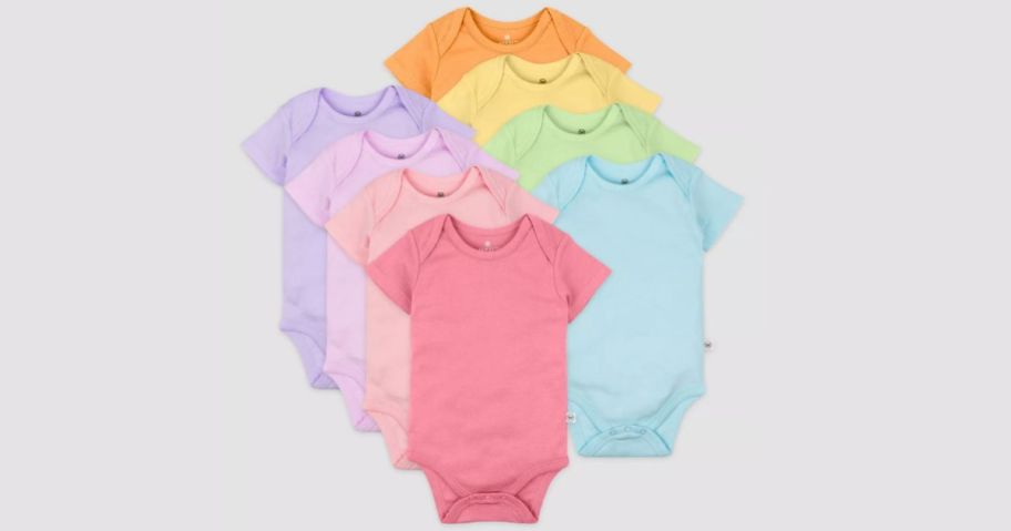 10 pack of honest baby bodysuits on grey background
