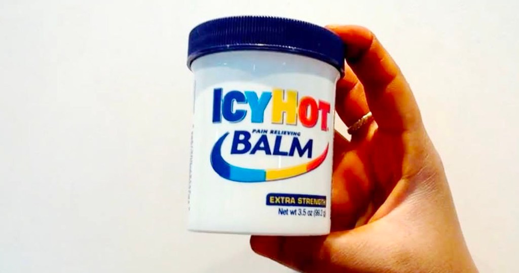 hand holding icy hot balm 