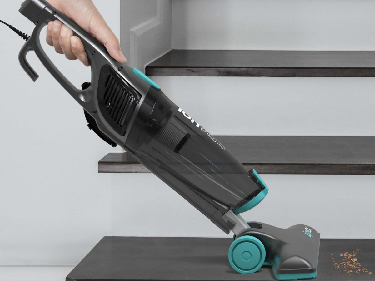 woman vacuuming stairs with an ionvac stick vac