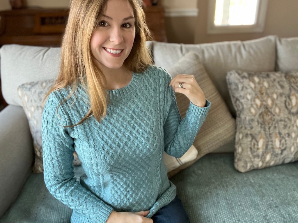 woman wearing blue knit sweater on couch