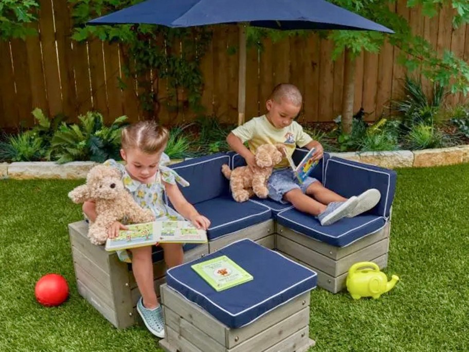 two kids sitting and reading on blue kidcraft outdoor sectional