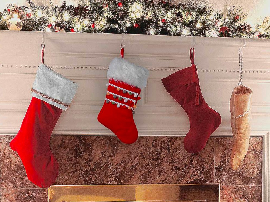 kohls red and white christmas stockings hanging on mantle