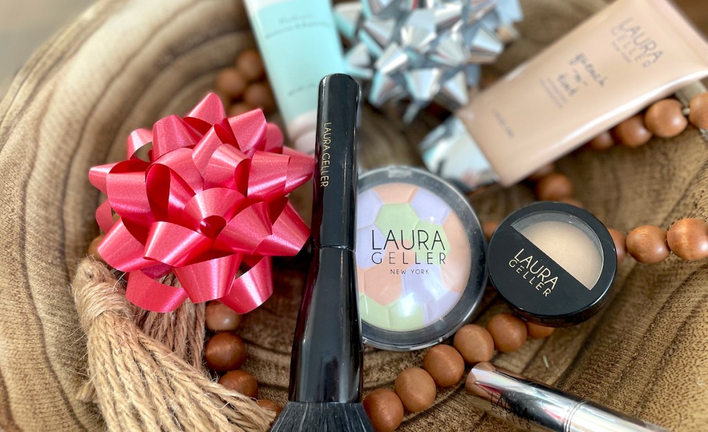 laura geller cosmetics on wood tray with holiday bows