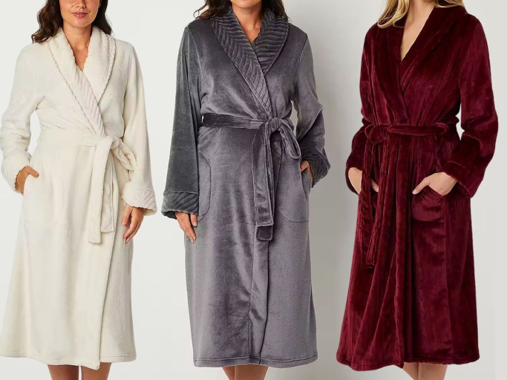 3 women wearing long length, long-sleeve plush robes in different colors