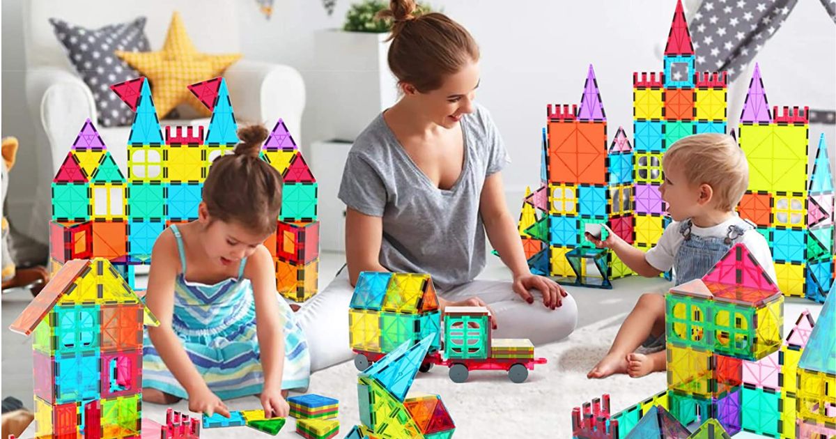 woman and two kids playing with magnetic tiles