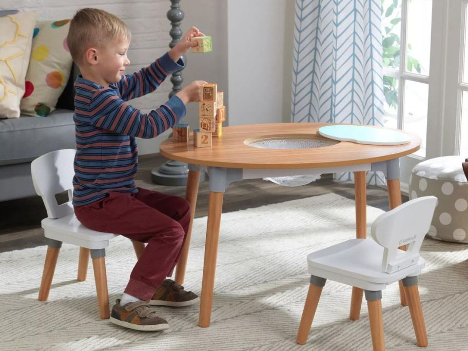 child playing on KidKraft Mid-Century Kid Toddler Table & 2 Chair Set