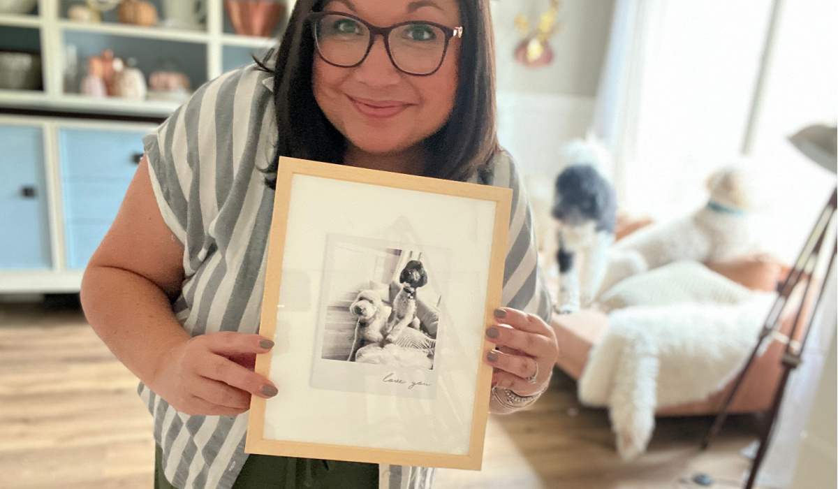 woman holding picture frame