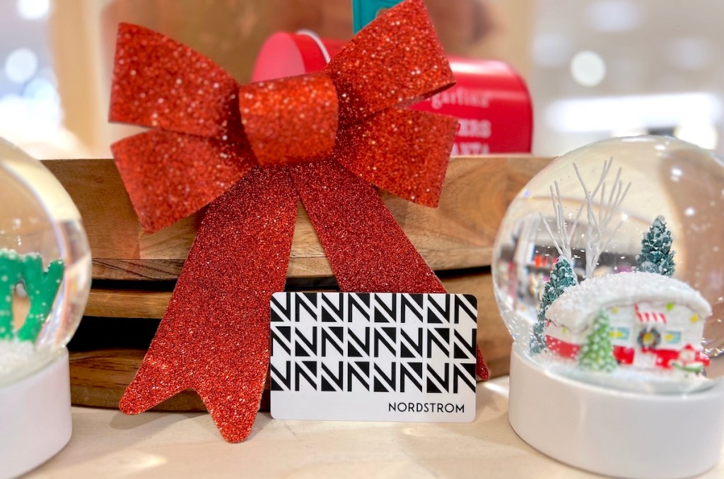 nordstrom gift card on counter with giant red bow