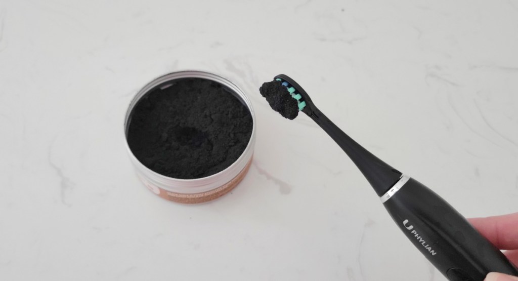 charcoal powder on toothbrush