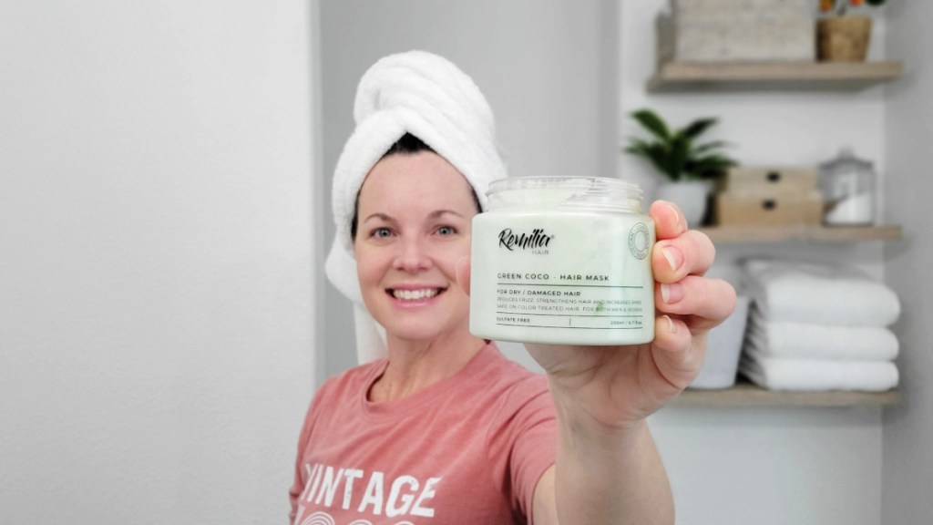 woman holding a jar of remilia hair mask