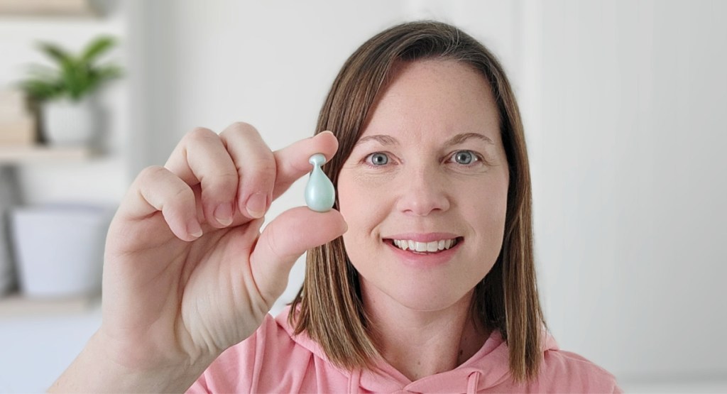 woman holding capsule