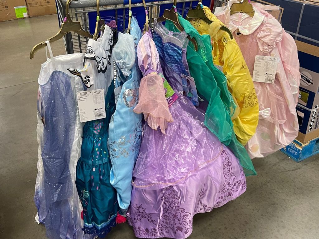 Halloween costumes hanging from shopping cart