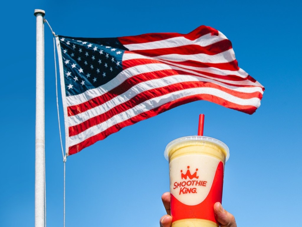 holding a smoothie under an American flag