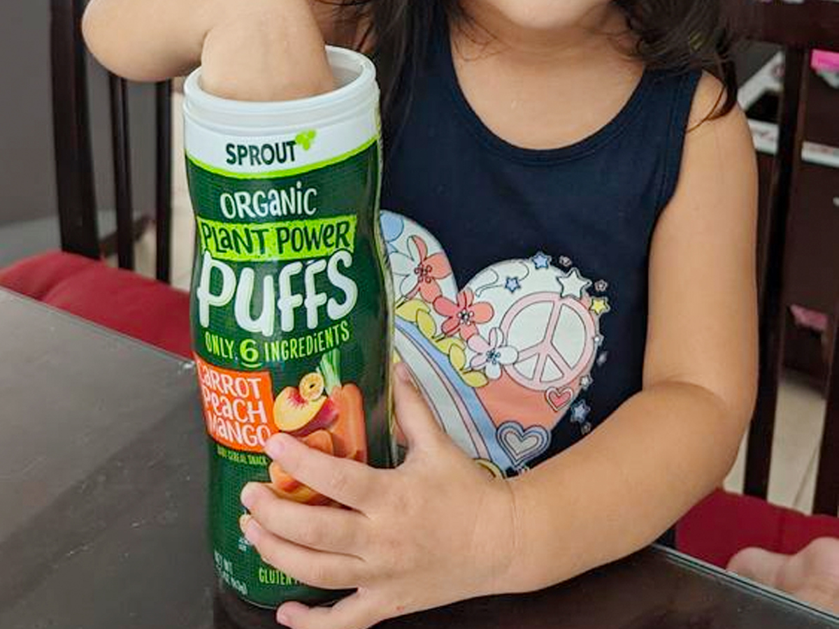 toddler with sprout puffs 