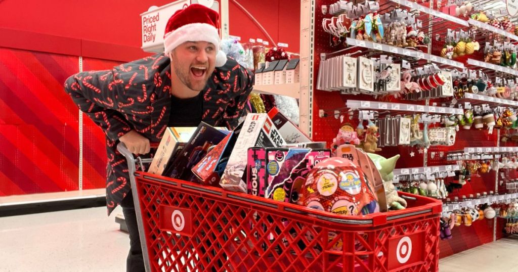 man in Christmas apparel behind Target cart full of toys