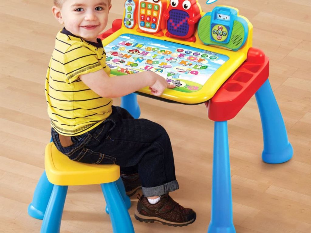 kid sitting at vtech activity table