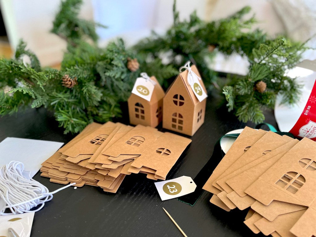cardboard house advent calendar on table with walmart christmas decorations
