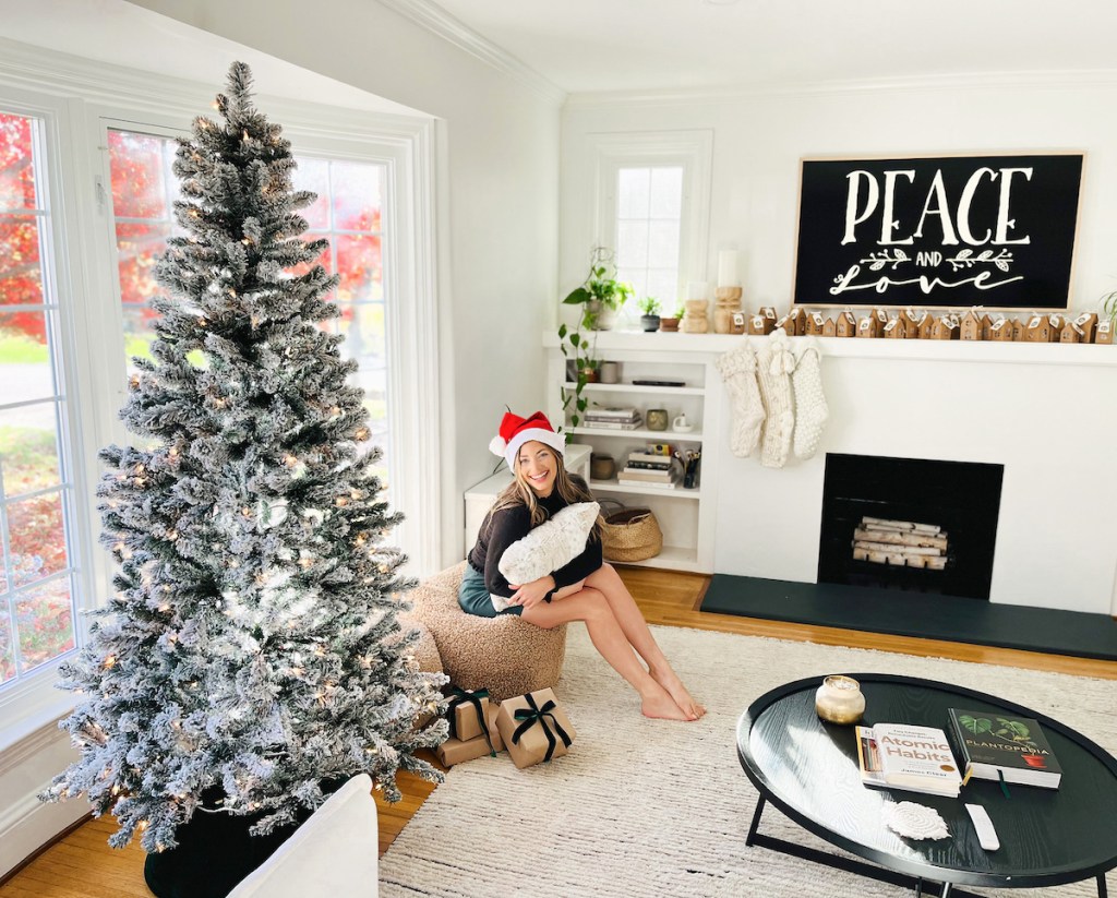 woman sitting in living room by walmart christmas decorations