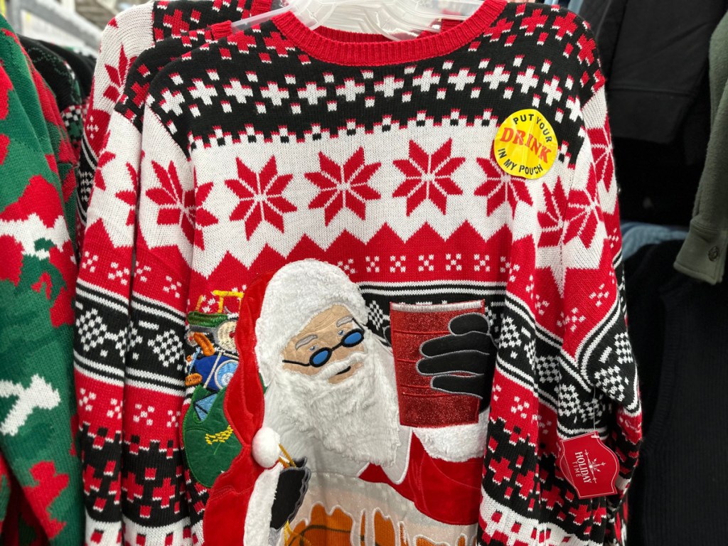 walmart christmas sweater depicting santa emerging from a chimney holding a red plastic cup